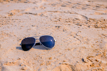 Sunglasses on the sea beach