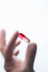 Hand holding capsule