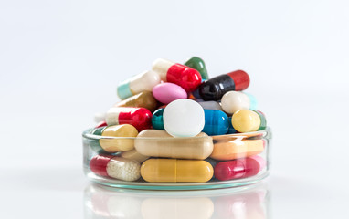 Various pills and capsules in glass containers symbole of medince addict