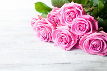 Pink roses on wooden