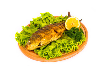 fish with lemon, parsley on kitchen board on a white background