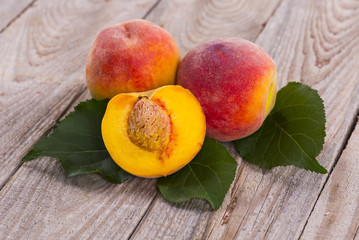 fresh peaches on wood background