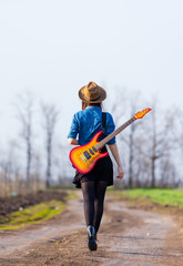 Naklejka premium photo of young woman with guitar