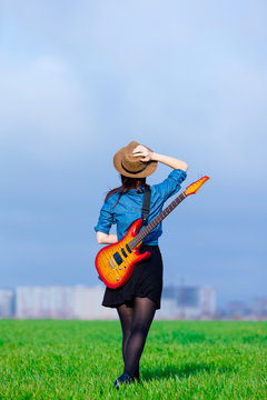photo of young woman with guitar