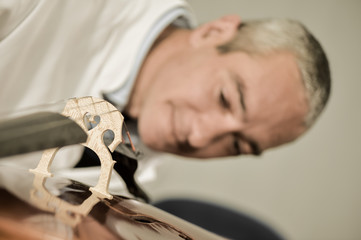 Artisan luthier working on the creation of violin.