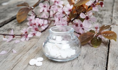 Schuessler Salze auf altem Tisch mit Kirschblüten