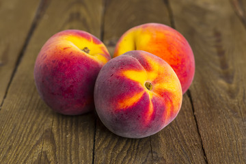 fresh peaches on wood background