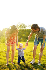 Happy family goes for a walk in park