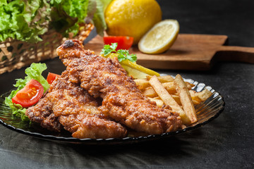 Fried fish in crispy batter with chips