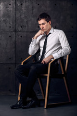 Successful businessman on a chair is thinking about his business