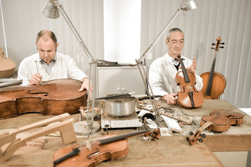Artisan luthier working on the creation of violin.