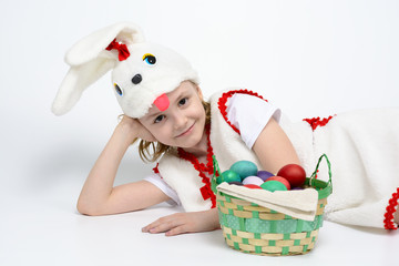 Girl in rabbit costume with a basket of Easter eggs