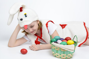 Girl in rabbit costume with a basket of Easter eggs