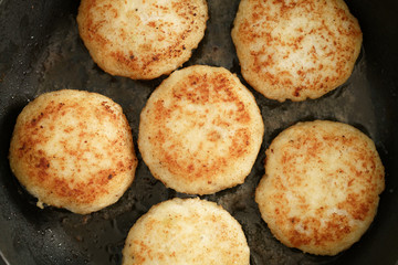 preparing fried fish cakes on pan, shallow focus