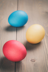 easter eggs on wooden table rustic style, vintage toned