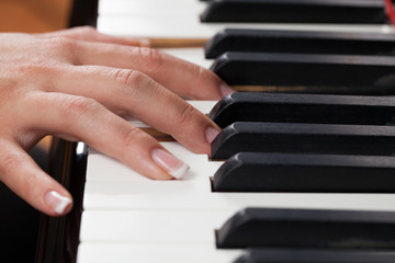Fototapeta premium A woman playing piano