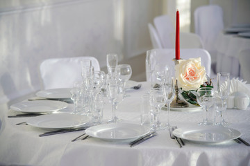 A festive table for a celebration. Banquet table with Cutlery and tableware. Table with white tablecloth served to guests. The table in the restaurant. Luxury Desk for the celebration.