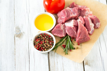 raw pork neck meat cut in pieces on wooden table