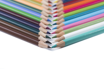 Naklejka premium colored pencils on a blank sheet of paper, ready to be used in design