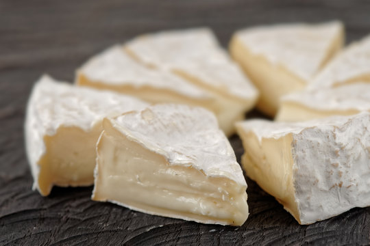 Head of brie cheese cut in pieces