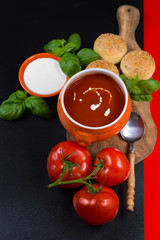 Fresh tomato cream- soup with green basil and bread