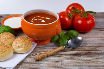 Fresh tomato cream- soup with green basil and bread