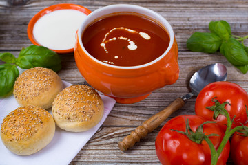 Fresh tomato cream- soup with green basil and bread