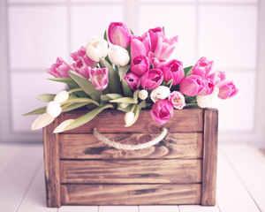 Pink and white tulips in a vintage wood crate