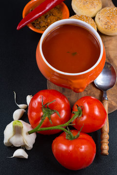 Fresh spiced tomato soup with garlic, pepper and bread