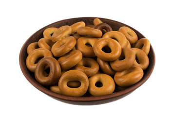 homemade  bagels on a clay plate isolated on white background.