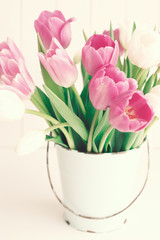Obraz premium Pink and white tulips in a vintage white tin bucket