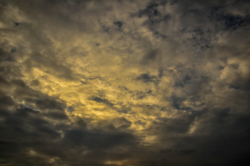Fototapeta na wymiar Dark clouds with yellow light photo