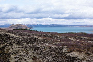Scenic countryside in South Iceland with volcanic rock and lake