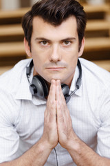 Portrait of young man sitting at the stairs in office