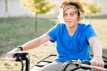 Boy riding farm truck in vineyard