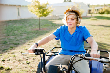 Obraz premium Boy riding farm truck in vineyard