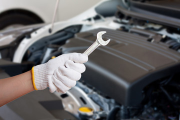 Hand of auto mechanic with wrench