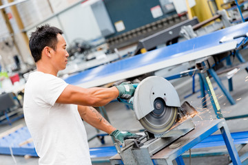 Asian worker in production plant on the factory floor