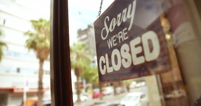Closed Sign on Glass Door of Coffee Shop
