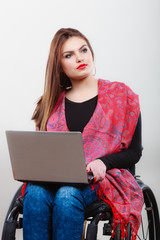 Woman invalid girl on wheelchair using computer