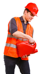 Worker in safety vest with oil fuel.