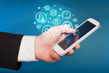 Hand holding smartphone with mobile app choices