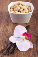 Pistachio nuts, blooming orchid and fragrant vanilla sticks, cosmetic ingredients