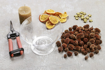 How to make candle holder decorated with cones and dried fruits.