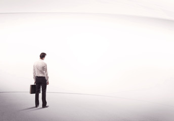 Businessman with briefcase standing still