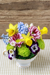Floral arrangement inside vintage ceramic cup