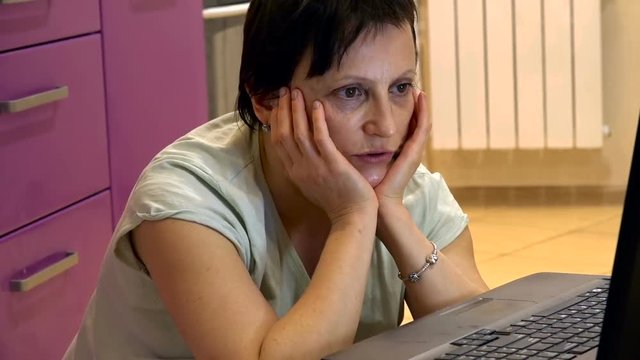 Mature Woman at Home in Front of Laptop Teaches English Online