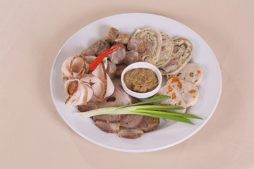 cold cuts of sausages, meat and pate served with mustard