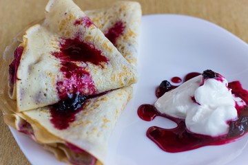 Pancakes with sour cream and berry jam