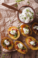 potato skins with cheese, bacon and sour cream close-up. Vertical top view
